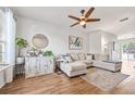 Bright living room featuring a comfortable sectional sofa, stylish decor, and a ceiling fan at 6541 Black Mangrove Dr, Largo, FL 33773