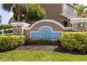 Community signage for Hidden Creek, surrounded by lush landscaping and manicured bushes at 6541 Black Mangrove Dr, Largo, FL 33773