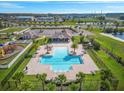 Aerial view of community pool, splash pad, playground, and clubhouse at 6937 Gideon Cir, Zephyrhills, FL 33541