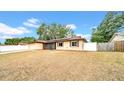 Single-story home featuring an attached garage, screened porch, and a well-maintained lawn at 812 Regent Circle S, Brandon, FL 33511