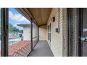 A screened in porch with brick accents, privacy screen, and outdoor lighting at 812 Regent Circle S, Brandon, FL 33511