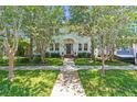 Inviting two-story home with mature trees and a well-maintained front yard at 834 26Th N Ave, St Petersburg, FL 33704