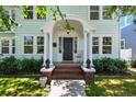 Elegant front porch with decorative columns and a charming seating area at 834 26Th N Ave, St Petersburg, FL 33704