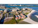 An aerial view highlighting the community's waterfront location near the beach and various community houses at 845 S Gulfview Blvd # 110, Clearwater Beach, FL 33767