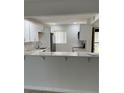 Bright kitchen features white cabinets, stainless steel appliances and a breakfast bar for casual dining at 845 S Gulfview Blvd # 110, Clearwater Beach, FL 33767