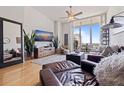 Sun-drenched living room features hardwood floors and a wall of windows at 1208 E Kennedy Blvd # 831, Tampa, FL 33602