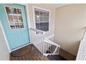 Inviting entryway with a bright blue door and brick steps at 12321 Sun Vista W Ct # 52, Treasure Island, FL 33706