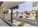 Charming townhouse complex showcasing manicured lawns and palm trees at 12321 Sun Vista W Ct # 52, Treasure Island, FL 33706