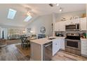 Modern kitchen featuring white cabinets, stainless steel appliances, and a breakfast nook at 12321 Sun Vista W Ct # 52, Treasure Island, FL 33706