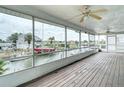Enclosed outdoor porch boasts stunning water views and a ceiling fan at 13918 Raie Ave, Hudson, FL 34667