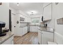 Bright kitchen with white cabinetry, stainless steel appliances, and stylish granite countertops at 1503 4Th St Sw, Largo, FL 33770