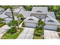 Inviting two-story townhouse with attached garage and attractive landscaping at 1628 Lullwater Ln, Lutz, FL 33549