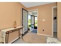 Entryway with tan walls, decorated table, and a glimpse into the screened-in porch at 16892 Delia St, Wimauma, FL 33598