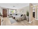 Spacious living room features modern sectional sofa, neutral paint, brick accent wall and ample natural light at 1726 York S St, Gulfport, FL 33707