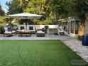 A serene backyard offers ample seating, a luxurious hot tub, and lush green turf, perfect for relaxation at 2278 Republic Dr, Dunedin, FL 34698