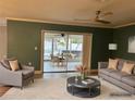 Inviting living room with plush seating and view to the patio's outdoor dining and spa at 2278 Republic Dr, Dunedin, FL 34698
