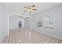 Bright and open living room featuring tiled floors and a ceiling fan at 2306 W Ivy St, Tampa, FL 33607