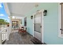 Charming front porch with white trim, classic lighting, and inviting seating at 2306 W Ivy St, Tampa, FL 33607