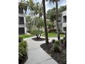 Scenic walkway lined with lush landscaping and trees in a well-maintained community at 2650 Countryside Blvd # C106, Clearwater, FL 33761