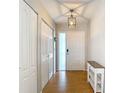 Inviting entryway featuring wood floors and decorative lighting fixture at 2707 Lakeville Dr, Tampa, FL 33618