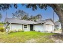 Charming single-story home featuring a well-manicured lawn, attached garage, and light-colored facade at 2707 Lakeville Dr, Tampa, FL 33618