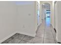 Bright hallway with tile flooring and neutral paint, leading to the main living area at 2882 Peony Prairie Ln, Wesley Chapel, FL 33543
