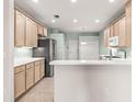 Well-lit kitchen with stainless steel appliances, ample counter space, and a breakfast bar at 30901 Prout Ct, Wesley Chapel, FL 33543