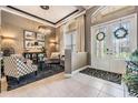 Elegant foyer featuring tile flooring, a chandelier, and a decorative rug, leading into the home at 3727 Janus Way, Palm Harbor, FL 34685