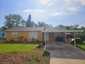 Charming single-story home features a covered parking area and a well-maintained front lawn at 404 12Th Sw St, Ruskin, FL 33570