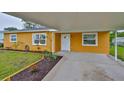 Charming single-story home with a well-maintained lawn and a covered carport at 404 12Th Sw St, Ruskin, FL 33570