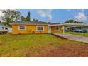 Charming single-story home with a well-maintained lawn and a covered carport at 404 12Th Sw St, Ruskin, FL 33570