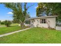 Charming single-story home featuring a well-manicured lawn, mature trees, and a welcoming front entrance at 4600 Chancellor Ne St, St Petersburg, FL 33703