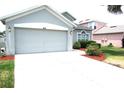 Picture of the home's exterior, featuring an attached garage and well-maintained front yard at 4633 Mapletree Loop, Wesley Chapel, FL 33544