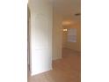 View of living room area with hard surface flooring and arched entry, great for entertaining at 4633 Mapletree Loop, Wesley Chapel, FL 33544
