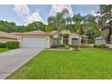 Well-maintained home features a spacious lawn, two-car garage, and vibrant curb appeal at 4942 Willow Ridge Ter, Valrico, FL 33596