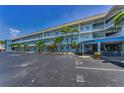 Condo building with balconies and palm trees, located at 5 Gateshead Drive with ample parking at 5 Gateshead Dr # 308, Dunedin, FL 34698