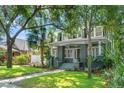 Charming two-story home with mature trees, manicured lawn, and inviting front porch at 516 14Th Ne Ave, St Petersburg, FL 33701