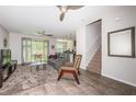 Bright living room with plush carpet, ceiling fan and sliding doors to the patio at 5225 5Th N Way, St Petersburg, FL 33703