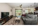 Comfortable living room featuring access to the patio, next to the kitchen, and nice tile flooring at 5225 5Th N Way, St Petersburg, FL 33703