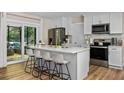 Bright kitchen features quartz counters, stainless appliances, and a sliding glass door to the patio at 616 11Th Nw St, Largo, FL 33770