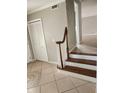 Foyer with tile flooring and staircase to second floor, plus a coat closet at 6906 Shady Pl, Tampa, FL 33634