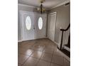Bright foyer with tile flooring, decorative mosaic, stairs and classic chandelier at 6906 Shady Pl, Tampa, FL 33634