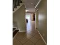 Hallway with tile flooring leading to the living room and pool area at 6906 Shady Pl, Tampa, FL 33634