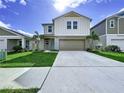 Attractive two-story home featuring a well-kept lawn and convenient two-car garage at 7554 Wallflower Trl, Wesley Chapel, FL 33545