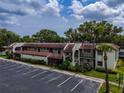 Aerial view showcases the building's architecture, parking, and surrounding landscape at 1100 East Bay Dr # 42, Largo, FL 33770
