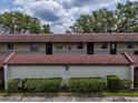 Exterior view of the condo featuring well-maintained landscaping and a shared outdoor space at 1100 East Bay Dr # 42, Largo, FL 33770
