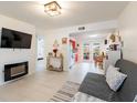 Bright living room with modern fireplace, tile floors, and access to dining area at 11104 Taft Dr, Port Richey, FL 34668