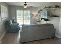 Comfortable living room featuring a sliding glass door, ceiling fan and modern furnishings at 11729 John Robbins Rd, Riverview, FL 33578