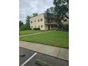 Exterior shot of a well-maintained apartment building with green lawn and sidewalks at 11802 Raintree Lake Ln # B, Temple Terrace, FL 33617