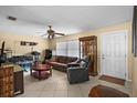 Inviting living room featuring tile floors, neutral wall color, and comfortable seating at 1226 Hermitage Ave, Clearwater, FL 33764